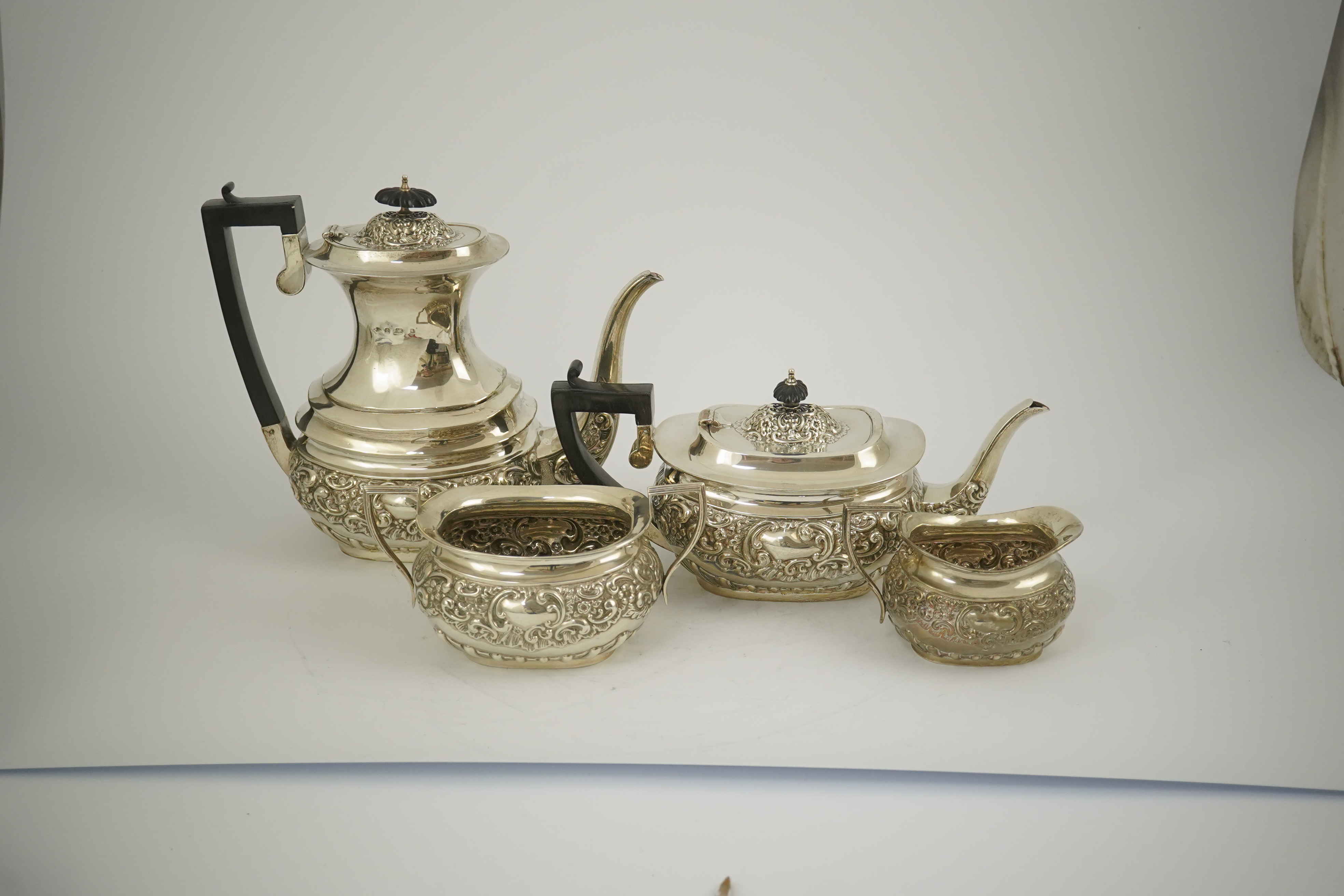 An Edwardian embossed silver four piece tea and coffee set, by S. Glass